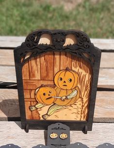 a wooden clock with two pumpkins on it