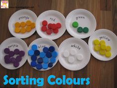 paper plates with different colored buttons on them and the words sorting colours written in white