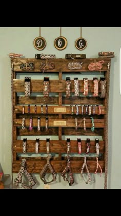 an old wooden rack with bracelets hanging on it