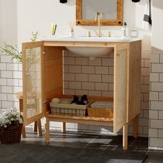 a bathroom with a sink, mirror and tiled walls in the background is a wooden cabinet