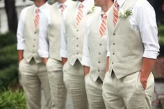 an image of a man in white suit and orange tie on his cell phone screen