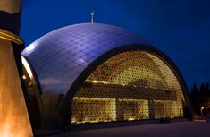 a large building with a blue dome on it's side and lights at the top