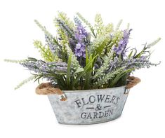 a metal bucket filled with purple and white flowers