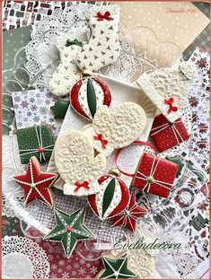 some cookies are laying on a plate and decorated with red, white and green decorations