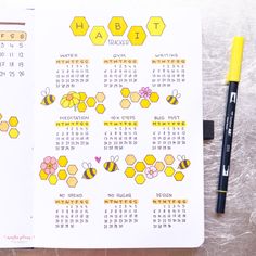 a calendar with bees on it next to a marker