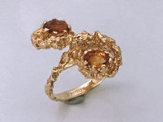 Rare Vintage 14kt Gold Brutalist Ring With Two Citrine Stones. Unique brutalist twist figure eight dome with two oval seated orange stones. Make a statement with this unique chunky piece of jewelry. Markings: SECO 14k Measurements: Ring Size 6, Stones- 5.4mm each Total Weight: 5.26 grams Condition: Great Vintage condition, ready to wear. Please review the photos for visual detail and let me know if you have any further questions prior to purchase. I don't offer returns or exchanges. USA sales on Unique Yellow Gold Topaz Ring For Formal Occasions, Unique Oval Yellow Gold Topaz Ring, Unique Citrine Ring In Yellow Gold, Yellow Gold Citrine Rings With Polished Finish, Unique Gold Topaz Ring, Unique Yellow Gold Sapphire Ring For Anniversary, Unique Yellow Gold Rings With Birthstone, Gold Multi-stone Topaz Ring In 14k Gold, Unique Yellow Gold Sapphire Ring For Formal Occasions