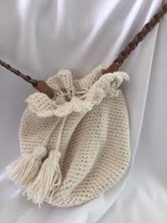 This boho scalloped edge shoulder bag is unlined, has a tassel tie and a leather shoulder strap. This is a very cute bag for a teenager or grandmother! Natural Crochet Shoulder Bag With Tassels, Bohemian Cream Handwoven Shoulder Bag, Bohemian Cream Woven Shoulder Bag, Bohemian Braided Beige Bag, Beach Shoulder Bag With Tassels, Rectangular Shape, Simi Valley, Scalloped Edge, Cute Bag, Shoulder Bags