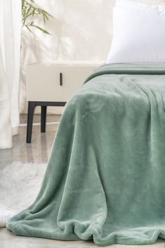 a bed with a green blanket on top of it