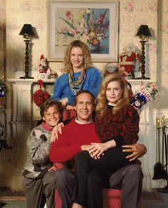 the cast of modern family poses for a portrait in their living room with christmas decorations on the fireplace