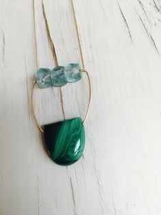 A refined slab of Malachite is blended with vintage glowing aqua glass and woven into this one of a kind statement necklace. Length is 24 inches Pendant size 2 inches MATERIAL: GOLD-FILLED - 14k Gold filled is considerably durable and considered a lifetime piece of jewelry. This is NOT gold plated or gold dipped vermeil jewelry which can chip off over time with wear. Gold filled metal is essentially a 14k gold tube filled with an inner core metal such as brass and has been mechanically bonded wi Artisan Green Necklace With Large Stone, Green Agate Necklace With Large Stone, Turquoise Glass Beads Jewelry, Handmade Turquoise Glass Necklace, Turquoise Glass Jewelry With Gemstone Beads, Handmade Adjustable Green Onyx Necklace, Handmade Glass Turquoise Necklace, Artisan Glass Necklaces For Healing, Crystal Gemstone Necklaces