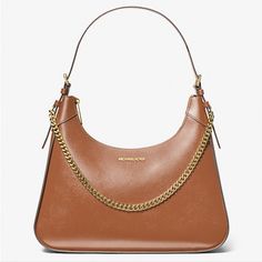 Michael Kors Wilma Large Luggage Smooth Leather Chain Shoulder Bag Introducing Wilma: A Sleek Shoulder Bag Made To Make A Statement. Featuring A Smooth Leather Exterior, It’s Cut In A Structured Silhouette And Features An Edgy Chain-Link Strap For Tough-Luxe Appeal. We Think It’s The Perfect Day-To-Night Bag 100% Leather From Tanneries Meeting The Highest Standards Of Environmental Performance Shoulder Bag Leather 100% Leather Gold-Tone Hardware 14.5”W X 12”H X 4”D Handle Drop: 11” Interior Deta Designer Chain Shoulder Bag For Travel, Designer Shoulder Bag With Chain For Travel, Everyday Leather Shoulder Bag With Gold Chain, Everyday Leather Bags With Gold Chain, Classic Leather Bag With Gold Chain, Classic Travel Bags With Chain Detail, Designer Leather Bag With Gold Chain, Elegant Brown Bag With Gold Chain, Leather Travel Bag With Chain Detail