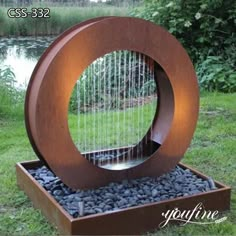 a sculpture made out of wood and rocks with a harp in it's center