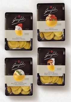 four packages of ravioli sitting on top of each other in front of a white background