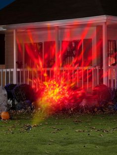 a house with red and yellow lights in the front yard