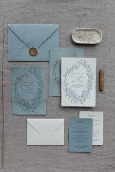 the wedding stationery is laid out and ready to be put into their guests'envelopes