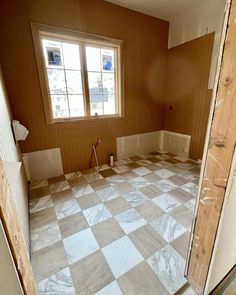 an empty room is being remodeled with wood and marble tiles on the floor in preparation for painting