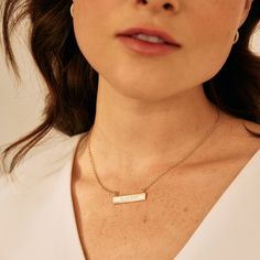 Commemorate a special memory with the Date Bar Necklace. This bar necklace will be custom engraved with your date of choice and is available in rose gold, yellow gold or rhodium-plated finishing options. A perfectly thoughtful gift for birthdays, anniversaries, and graduations. Available in 14k gold plated, rhodium plated or 14k rose gold plated brass Bar size: 1 1/4" by 1/4" 16" cable chain with 2" extender Lobster claw closure With engraving this item is FINAL SALE SKU: BYN1078 Minimalist Anniversary Bar Necklace With Delicate Chain, Minimalist Bar Necklace With Delicate Chain For Anniversary, Minimalist Delicate Chain Bar Necklace For Anniversary, Personalized Bar Necklace For Anniversary, Elegant Engraved Text Jewelry, Minimalist Rose Gold Bar Necklace For Anniversary, Classic Engraved Bar Necklace As Gift, Classic Engraved Bar Necklace For Gift, Minimalist Bar Necklace For Anniversary Or Mother's Day