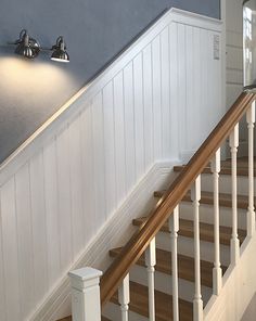 there is a light that is on the wall above the bannister in this house