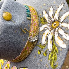 This "Peace Hippie" Hand Painted Hat is a one-of-a-kind work of art. This hat is just FUN!!! It has a hat band and the letters, PEACE created from a piece of an abstract painting on artist canvas. A huge hand painted daisy, lots of vintage golden trim, hand stitched little turquoise beads and a one of a kind hat pin with a cool golden bead!. WB-114Carmen has added a magical dimension to the design, using a wood-burning tool to create the engravings. This hat will come with a signed and dated pai Hat Trimming Ideas, Hand Painted Hats For Women, Cowgirl Hat Ideas, Painted Apparel, Ok Corral, Hand Painted Hats, Burned Hats, Art Hats, Cowboy Hat Design