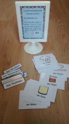 a computer screen sitting on top of a wooden table next to some papers and magnets