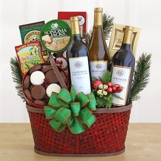 a basket filled with wine and snacks on top of a table