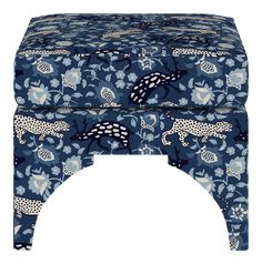 a blue foot stool with leopards and flowers on it