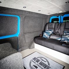 the interior of a vehicle with two seats and a rug on the floor next to it