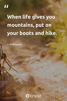 a pair of hiking boots sitting on the ground with a quote about life gives you mountains, put on your boots and hike