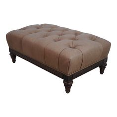 a brown ottoman sitting on top of a wooden frame