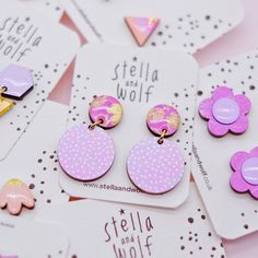 Another take on our best selling earrings,  these Contemporary polka dot drops have been hand painted in lilac and pink with a tiny white polka dot design . The attached studs have been painted in a bubblegum pink and embellished with a touch of gold leaf  for a little bit of sparkle.  Earrings are made of two wooden flat discs joined with a gold plated jump ring and backed with a plated earring post and butterfly. Earrings are coated in part resin and part varnish to protect and give a high gloss finish. Measurements are approximate drop 3cm  w 2cm To keep your Stella and Wolf jewellery in perfect condition, we recommend that you avoid contact with water, perfume, sun cream and body lotions. Each item comes carefully and beautifully wrapped in pretty tissue paper and with a S&W sticker Playful Purple Earrings For Gift, Playful Purple Earrings For Gifts, Playful Pink Round Earrings, Playful Hand Painted Pink Earrings, Playful Hand Painted Pink Jewelry, Playful Pink Hand-painted Jewelry, Playful Pink Hand Painted Jewelry, Hand Painted Pink Round Earrings, Cute Pink Hand Painted Earrings