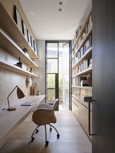 a home office with shelves and desks