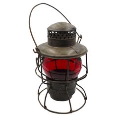 an old metal lantern with a red light inside on a white background for use as a decoration