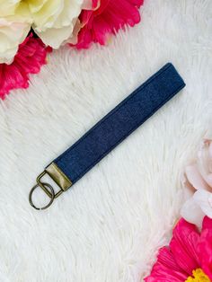 a pair of scissors sitting on top of a white rug next to pink and yellow flowers