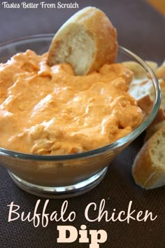 buffalo chicken dip in a glass bowl with bread on the side