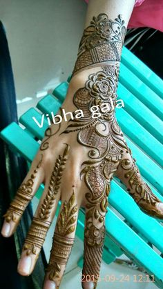 a woman's hand with henna tattoos on it