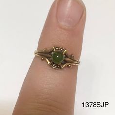 Smaller gold colored ring with small round jade colored stone. Vintage ring inventory form my great grandmother's restaurant and gift shop in Silverton, CO that she owned and operated from the 1960s to 1996. Style 1378SJP Sizes available: Size 4 - qty 2 Size 4.5 - qty 4 Size 5 - qty 2 Antique Gold Round Emerald Ring, Gold Emerald Ring With Round Stone, Vintage Green Opal Ring, Vintage Gold Opal Promise Ring, Vintage Opal Ring Stamped 14k, Gold Vintage Opal Promise Ring, Vintage 14k Stamped Opal Ring, Vintage Gold Jewelry With Round Stone, Vintage Green Opal Ring For Anniversary