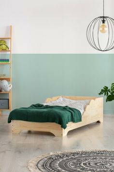 a bedroom with a bed, rug and green walls