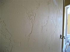 a white wall with peeling paint on it