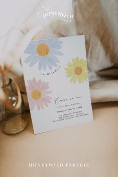 a close up of a card with flowers on it next to a pair of shoes