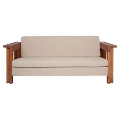 a beige couch sitting on top of a wooden frame