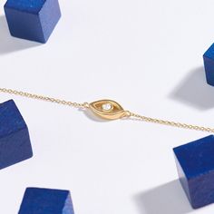 xEvoke an aura of protection and style with our Evil Eye Bracelet. This elegant and symbolic piece showcases the classic evil eye motif, believed to ward off negative energies and bring good fortune. Crafted in radiant gold, the delicate design is both fashionable and meaningful. Adorn your wrist with this timeless talisman to not only enhance your look but also invite positivity and ward off negativity. Elevate your jewelry collection with this enchanting and culturally significant bracelet. - Gold Spiritual Evil Eye Bracelet Gift, Yellow Gold Evil Eye Bracelets As Gift, Minimalist Gold Bracelets With Evil Eye, Gold Minimalist Bracelet With Evil Eye, Minimalist Gold Bracelet With Evil Eye, Yellow Gold Evil Eye Bracelet Gift, Gold Bracelets With Diamond Eyes As A Gift, Gold Bracelet With Evil Eye For Gift, Spiritual Yellow Gold Bracelet