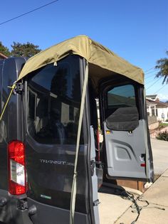 the back door of a van with an awning on it