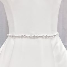 a white dress with a belt on it