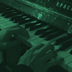 a person is playing the piano with their hands