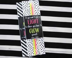 there is a black and white striped background with a sign that says, if you want to light a rainbow, do others you have to glow yourself