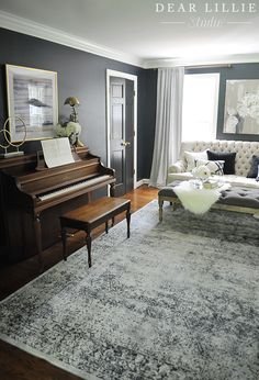 a living room filled with furniture and a piano