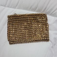 Lovely antique Whiting and Davis gold mesh coin purse.  This little purse is uncommon, and the mesh is made of 3-D raised square gold beads.  It is a weighty little bag.  The gold has darkened, and the purse has the patina of age.  The bag has a zipper and a chain pull, and bears the Whiting and Davis label on the inside lining.  It measures  4" by 5" and is in good pre-owned condition for a piece this age. Luxury Vintage Clutch Coin Purse, Gold Square Evening Bag, Vintage Handmade Gold Coin Purse, Vintage Gold Handmade Coin Purse, Handmade Vintage Gold Coin Purse, Gold Rectangular Clutch For Fashion Accessory, Gold Bags With Gold Beads For Gifts, Gold Rectangular Evening Bag, Gold Square Evening Bag As A Gift