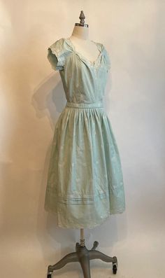 "Rare Clare Potter mint green embroidered floral cotton dress has scalloped sleeves, hem and neckline with a matching belt with a single covered button. Dress zips up in the back and is in excellent vintage condition. The bodice on the dress seems too have been made for someone with a long torso, so please mind the measurements listed below! Shoulders 17\" Chest 38-40\" Waist 28\" Hips 60\" Underarm seam to waist seam 9\" Length from top of shoulder to hem 45\" Vintage garments have been previou Elegant Cotton Dress With Scalloped Edges, Classic Broderie Anglaise Dresses, Classic Green Cotton Dress, Classic Cotton Vintage Dress For Spring, 1950s Style Tea Length Dresses, Fitted Cotton Dress With Scalloped Edges, Cotton Broderie Anglaise Knee-length Dress, Cotton Dresses With Scalloped Edges And Short Sleeves, Vintage Broderie Anglaise Dress For Daywear