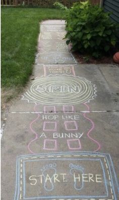 some chalk drawings on the sidewalk in front of a house