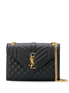 Black calf leather Cassandra quilted shoulder bag from Saint Laurent featuring signature YSL logo plaque, gold-tone hardware, quilted finish, envelope design, leather and chain-link shoulder strap, front flap closure, magnetic fastening, main compartment and internal slip pocket. | Saint Laurent Cassandra quilted shoulder bag Embroidered Shoulder Bag, Quilted Shoulder Bag, Ysl Logo, Oversized Tote Bag, Quilted Purses, Yves Saint Laurent Bags, Black Leather Crossbody Bag, Envelope Design, Material Girl